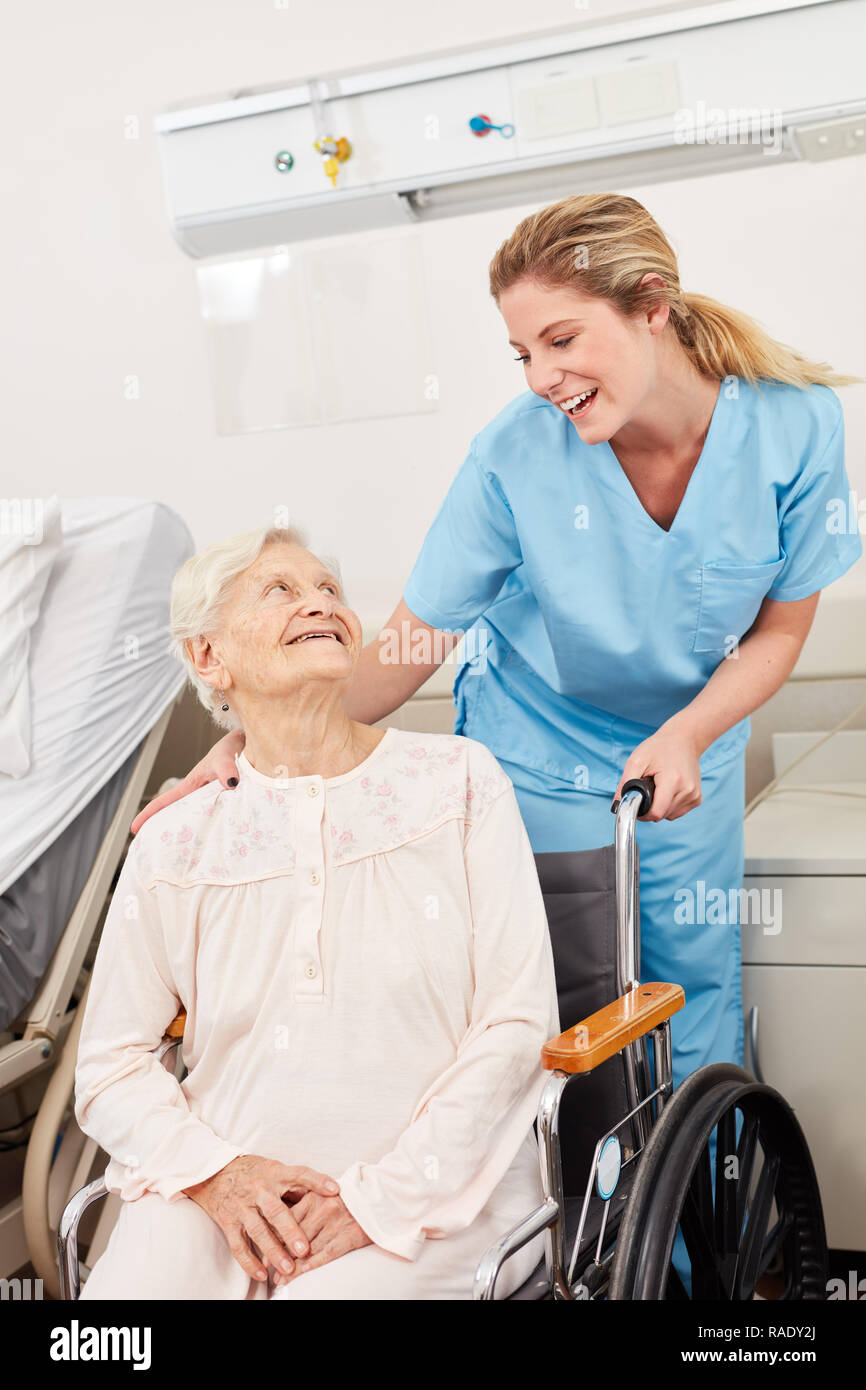 Nurse nursing stuff take care of dependend patient in wheelchair Stock  Photo - Alamy