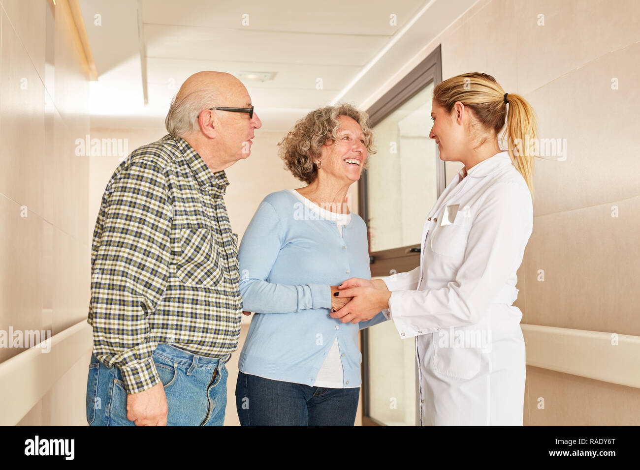 Seniors shaking hands Hands with geriatric nurse in retirement home Stock Photo