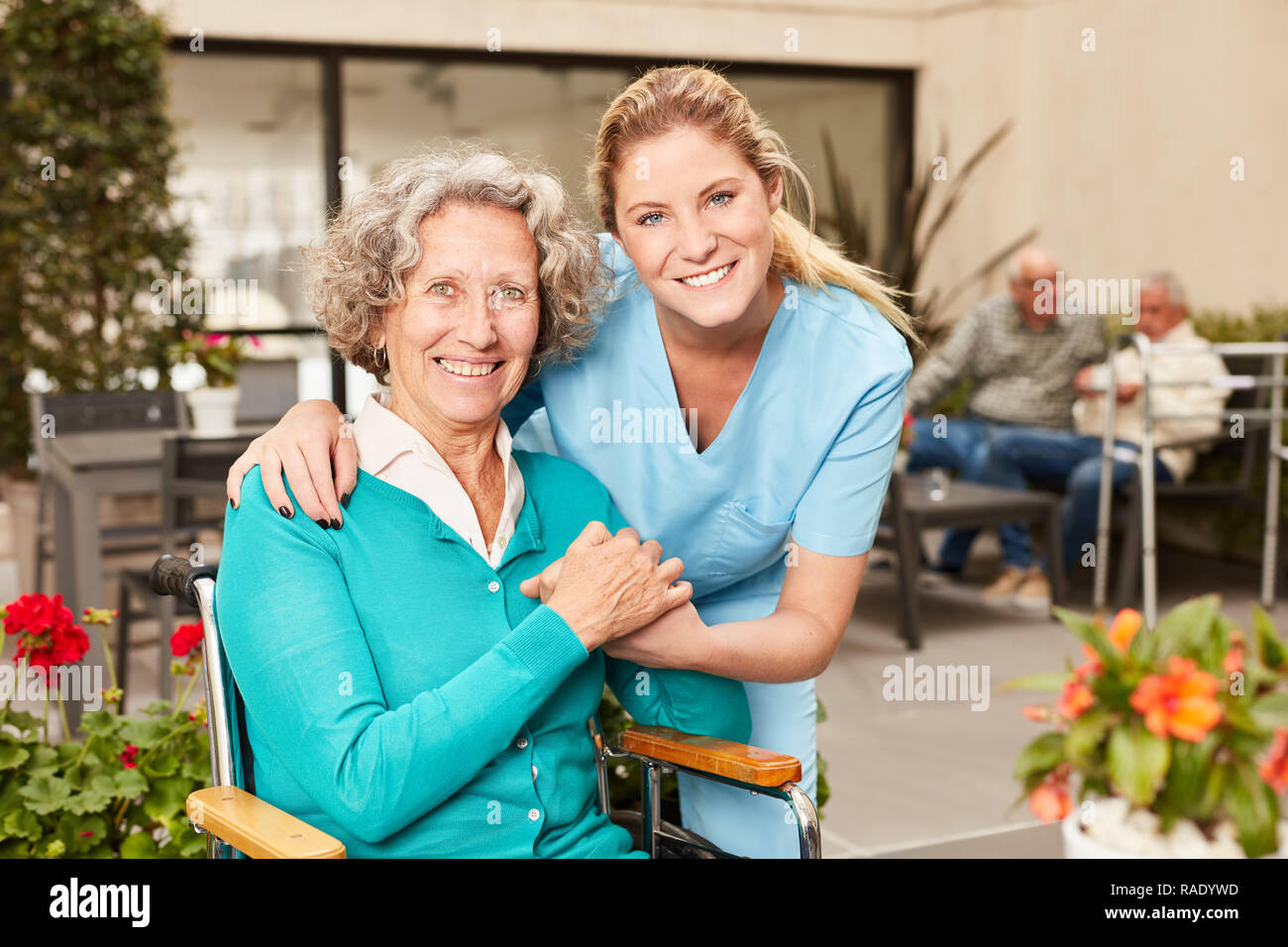 Happy senior woman and nursing assistant or geriatric nurse in retirement home Stock Photo