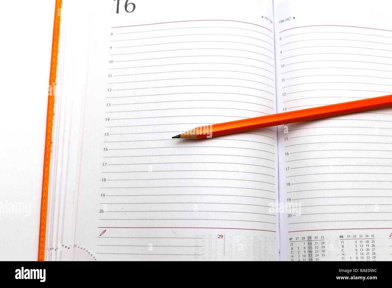 opened notepad and pencil on a white close up shoot Stock Photo