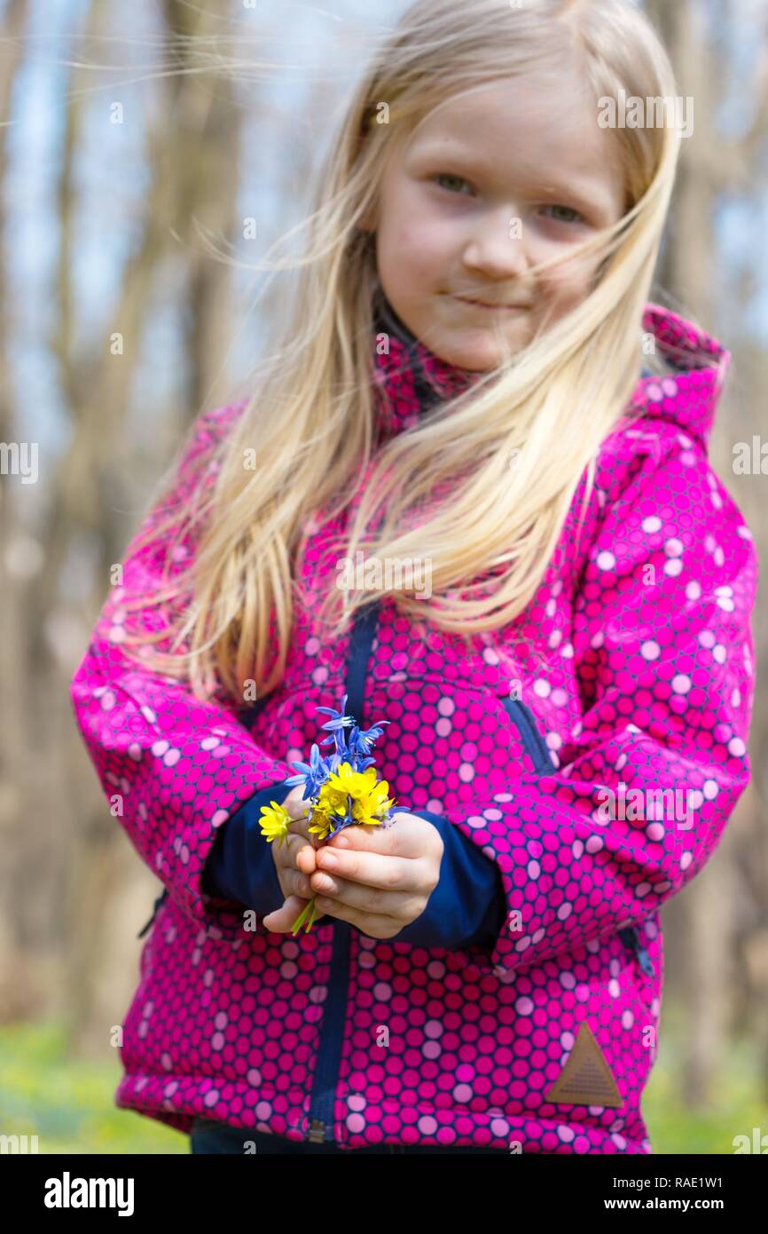 Norwegian girl holding a bouquet of wildflowers Stock Photo
