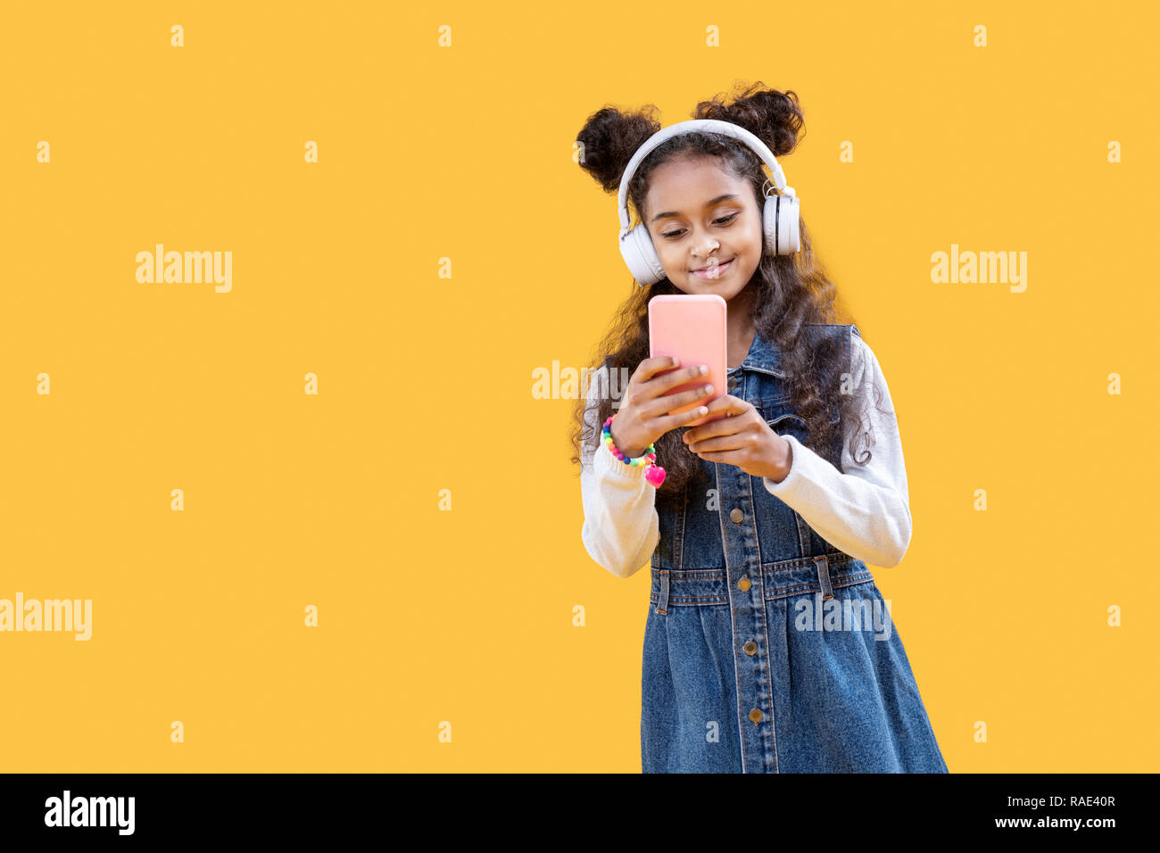Happy delighted girl listening to music in headphones Stock Photo