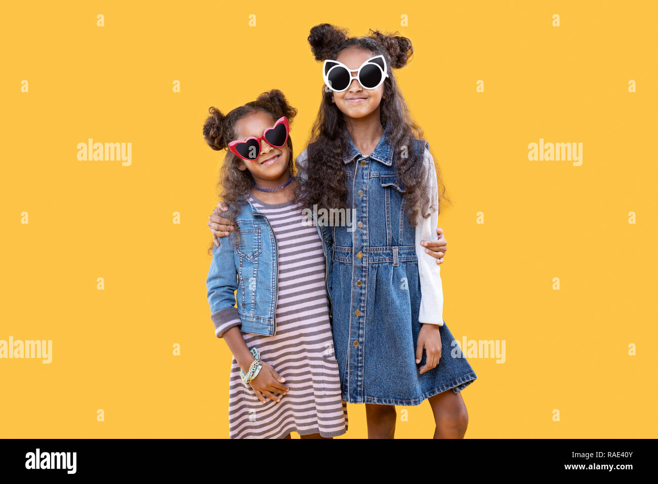 Joyful happy young sisters hugging each other Stock Photo