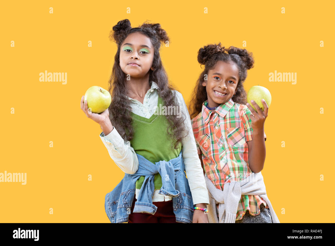 Nice happy girls showing you healthy food Stock Photo