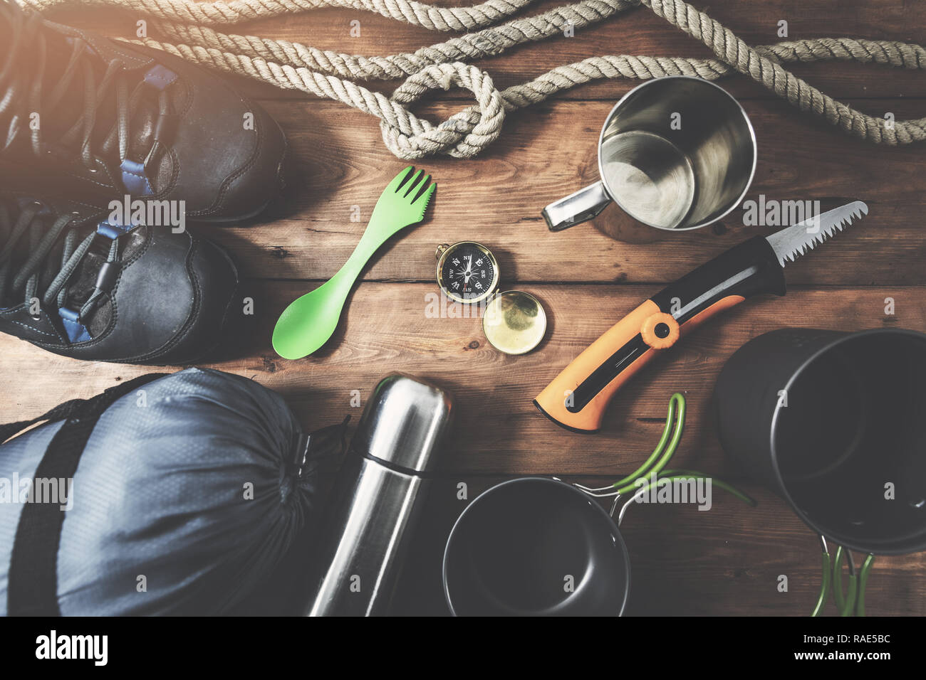 expedition camping equipment on wooden plank background. top view Stock Photo