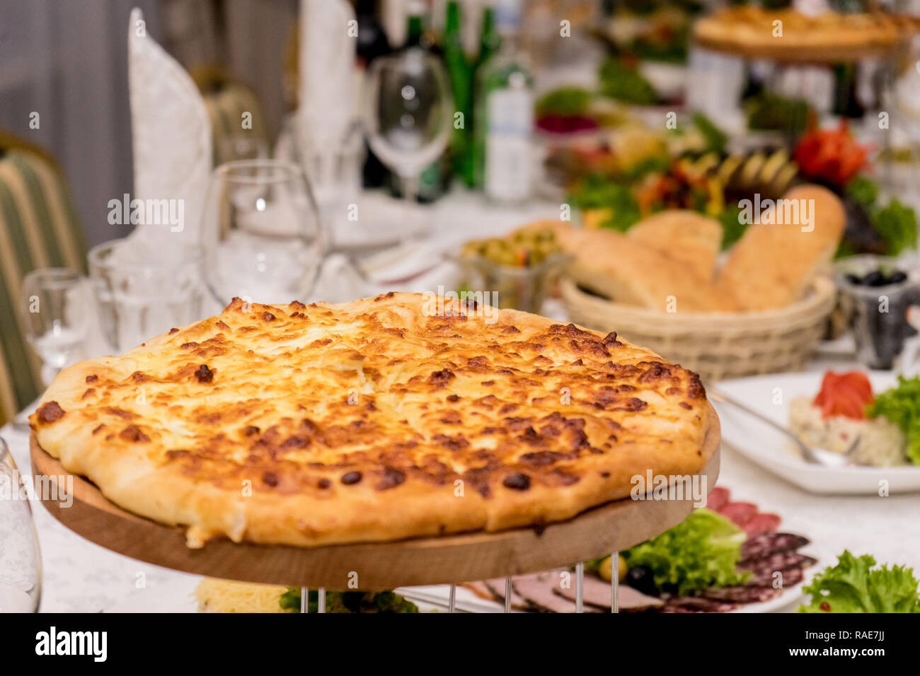 big tasty appetizing pizza 4 cheese close-up on the background of the holiday table Stock Photo