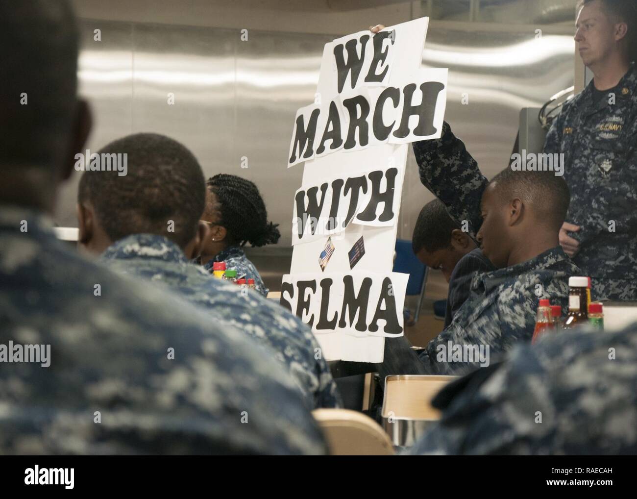 SANTA RITA, Guam (Jan. 31, 2017) Sailors assigned to the submarine tender USS Frank Cable (AS 40), attend a ceremony honoring Dr. Martin Luther King Jr. aboard the ship, Jan. 31. The ship’s diversity committee held the event to reenact the1965 Selma-to-Montgomery, Alabama March for voting rights led by Martin Luther King Jr.’s Southern Christian Leadership Conference. Frank Cable is one of two forward-deployed submarine tenders in the U.S. 7th Fleet area of operations and conducts maintenance and support of deployed U.S. naval force submarines and surface vessels in the Indo-Asia-Pacific regio Stock Photo