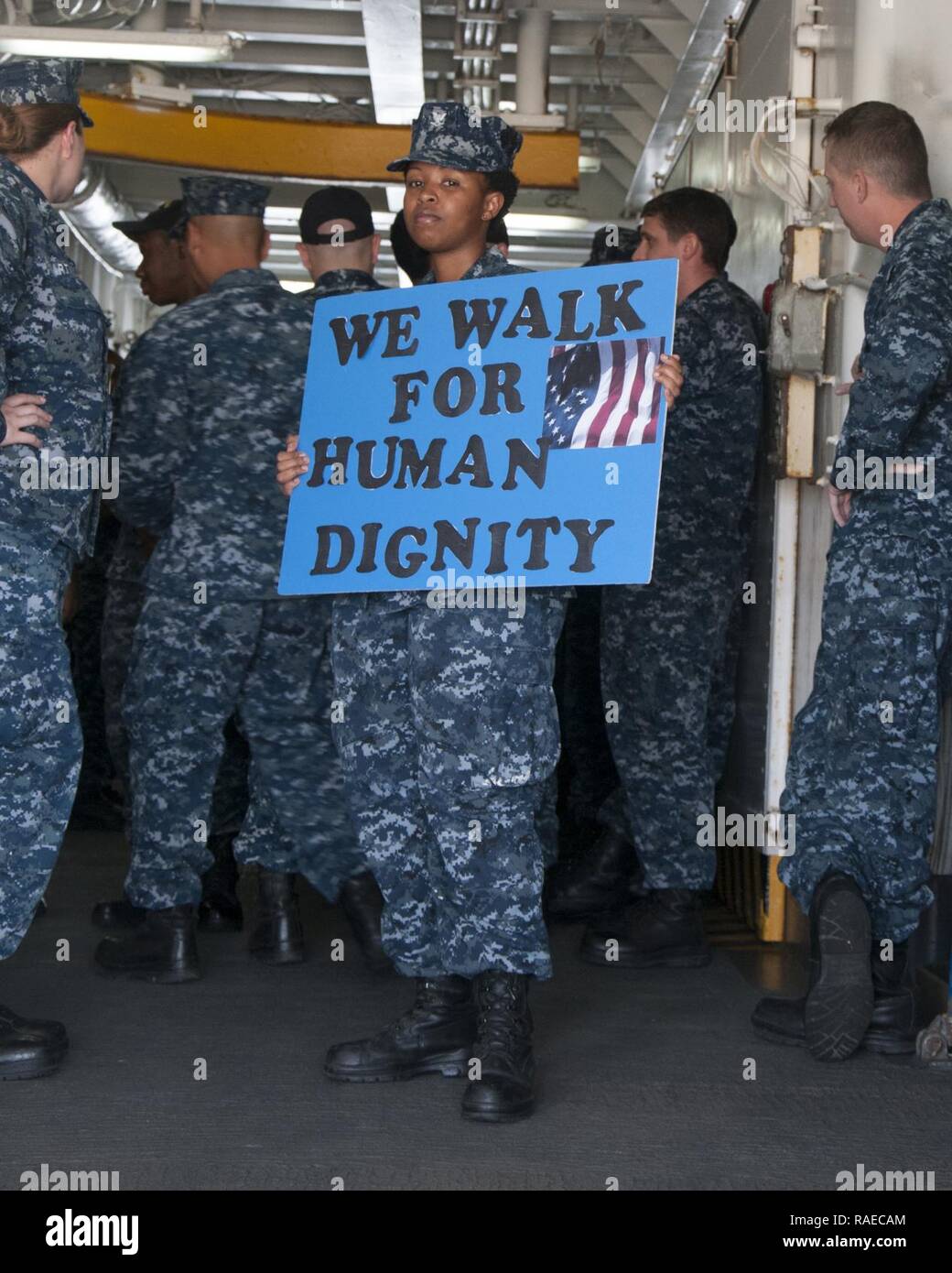 SANTA RITA, Guam (Jan. 31, 2017) Hospital Corpsman 3rd Class Sophie Karanja, a Sailor assigned to the submarine tender USS Frank Cable (AS 40), holds a sign before beginning a march honoring Dr. Martin Luther King Jr. aboard the ship, January 31. The ship’s diversity committee held the event to reenact the1965 Selma-to-Montgomery March for voting rights led by Martin Luther King Jr.’s Southern Christian Leadership Conference. Stock Photo