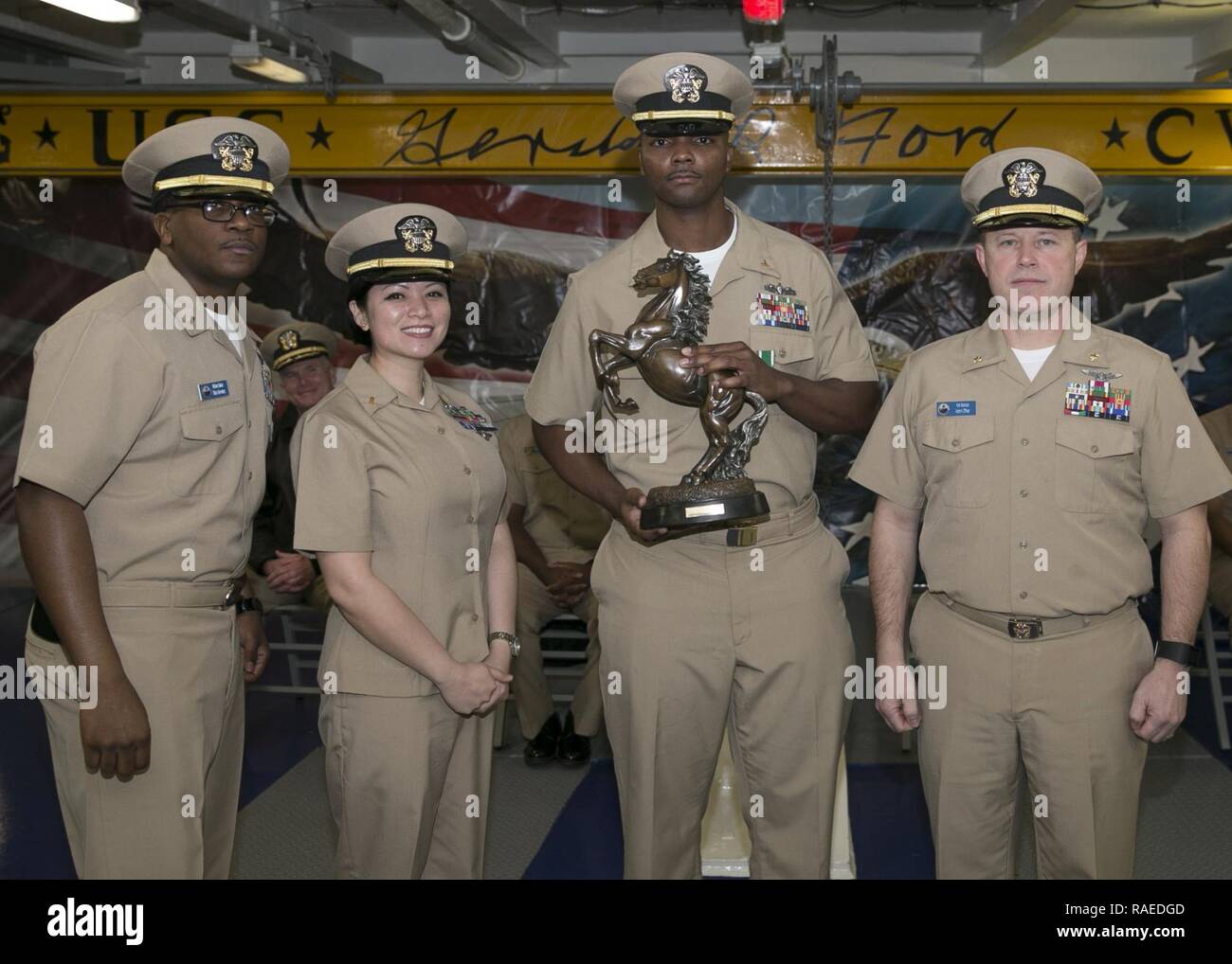 NEWPORT NEWS, Va. (Feb. 1, 2017) - Chief Personnel Specialist Michael Payne, assigned to Pre-Commissioning Unit Gerald R. Ford (CVN 78), is presented with a gift from fellow administration officers during his commissioning ceremony inside the ship's forecastle. Stock Photo