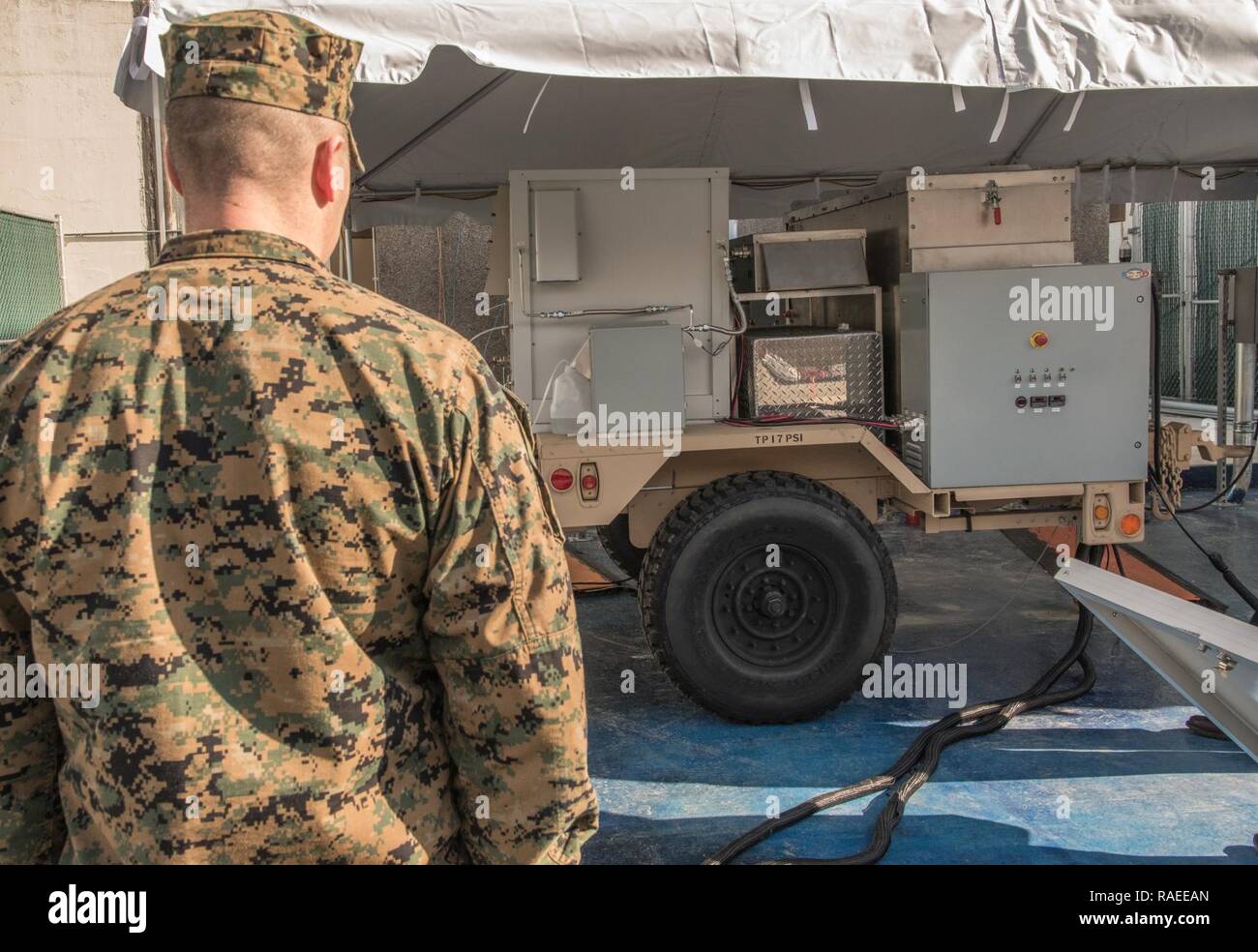 Lt. Col. William P. Dobbins, an engineer for U.S. Marine Corps Forces Command, watches a demonstration and test kickoff of the first logistics fuel (JP-8) compatible renewable-hybrid Solid Oxide Fuel Cell (SOFC) system Jan. 26, 2017, at Naval Surface Warfare Center, Carderock Division in West Bethesda, Md. Stock Photo