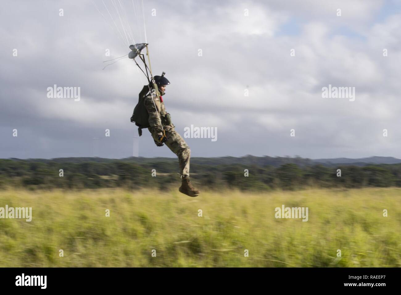 NORTH SHORE, Hawaii (Jan. 26, 2017) Sgt. 1st Class Anthony Rucker, assigned to Special Operations Command Pacific, prepares to land during airborne training operations, Jan. 26, 2017. As a sub-unified command of U.S. Special Operations Command under the operational control of U.S. Pacific Command, SOCPAC serves as the functional component for all special operation missions deployed throughout the Indo-Asia-Pacific region. Stock Photo