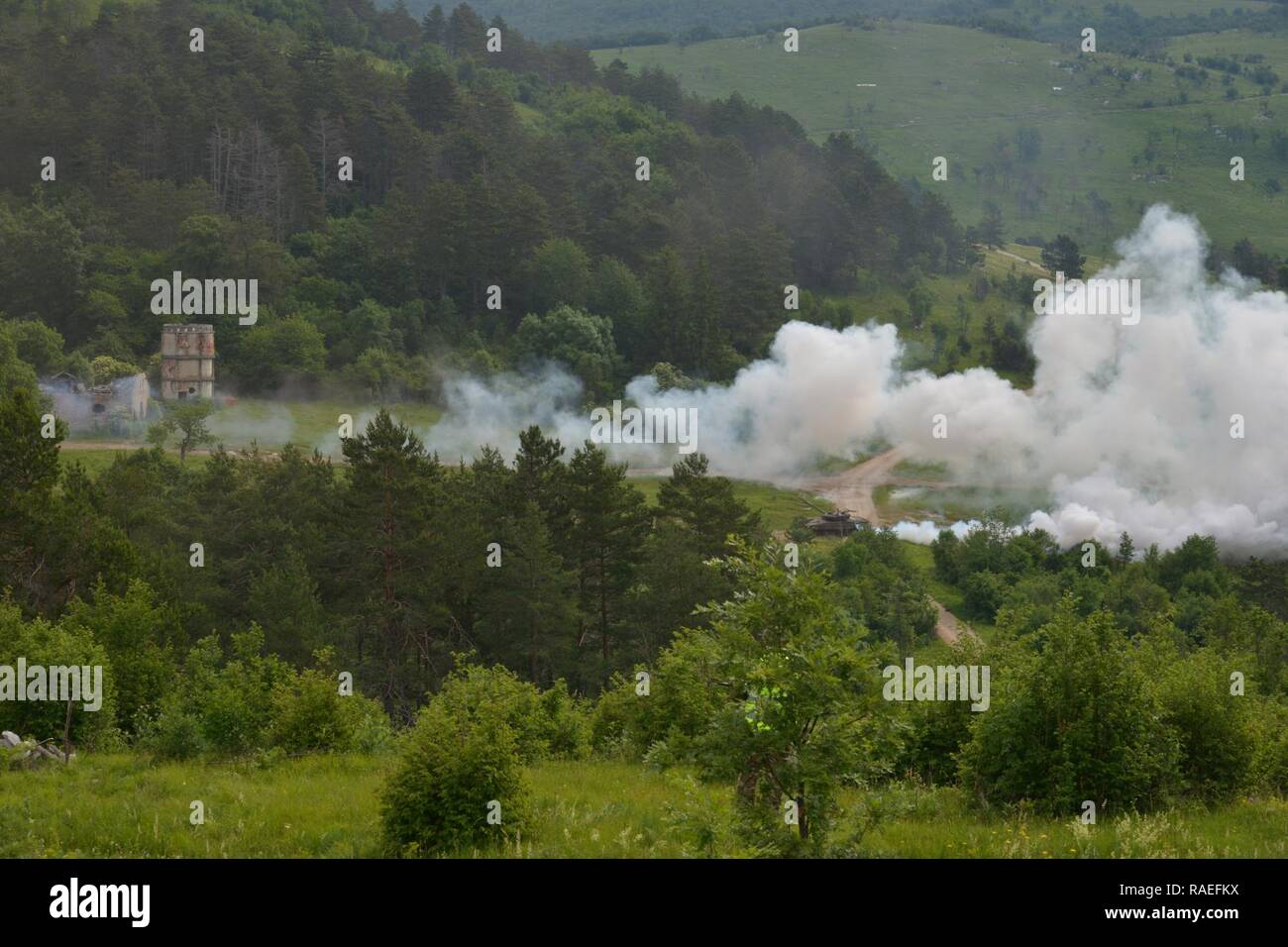 Slovenian M84 tank fires on targets called in by paratroopers from the NATO allies during a call for fire for Exercise Adriatic Strike at Pocek Range in Postonja, Slovenia, June 6, 2017. This training gives U.S. joint terminal attack controllers the chance to work directly with the militaries of other partner nations. The exercise brought together NATO allies from the U.S. and Slovenian militaries to rehearse critical skills in support of ground operations Stock Photo