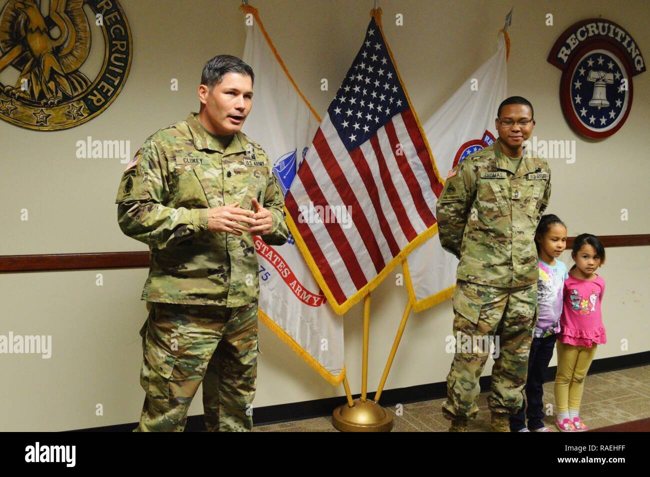 Lt. Col. David Clukey (left), commander, Phoenix Recruiting Battalion, praises Master Sgt. Redus Thomas, operations noncommissioned officer in charge, Phoenix Rec. Bn., during a promotion ceremony for Thomas, Feb. 1, 2017, battalion headquarters, Phoenix. Thomas was joined for the ceremony by his daughters Kaylah (left) and Lilyona (right). Stock Photo