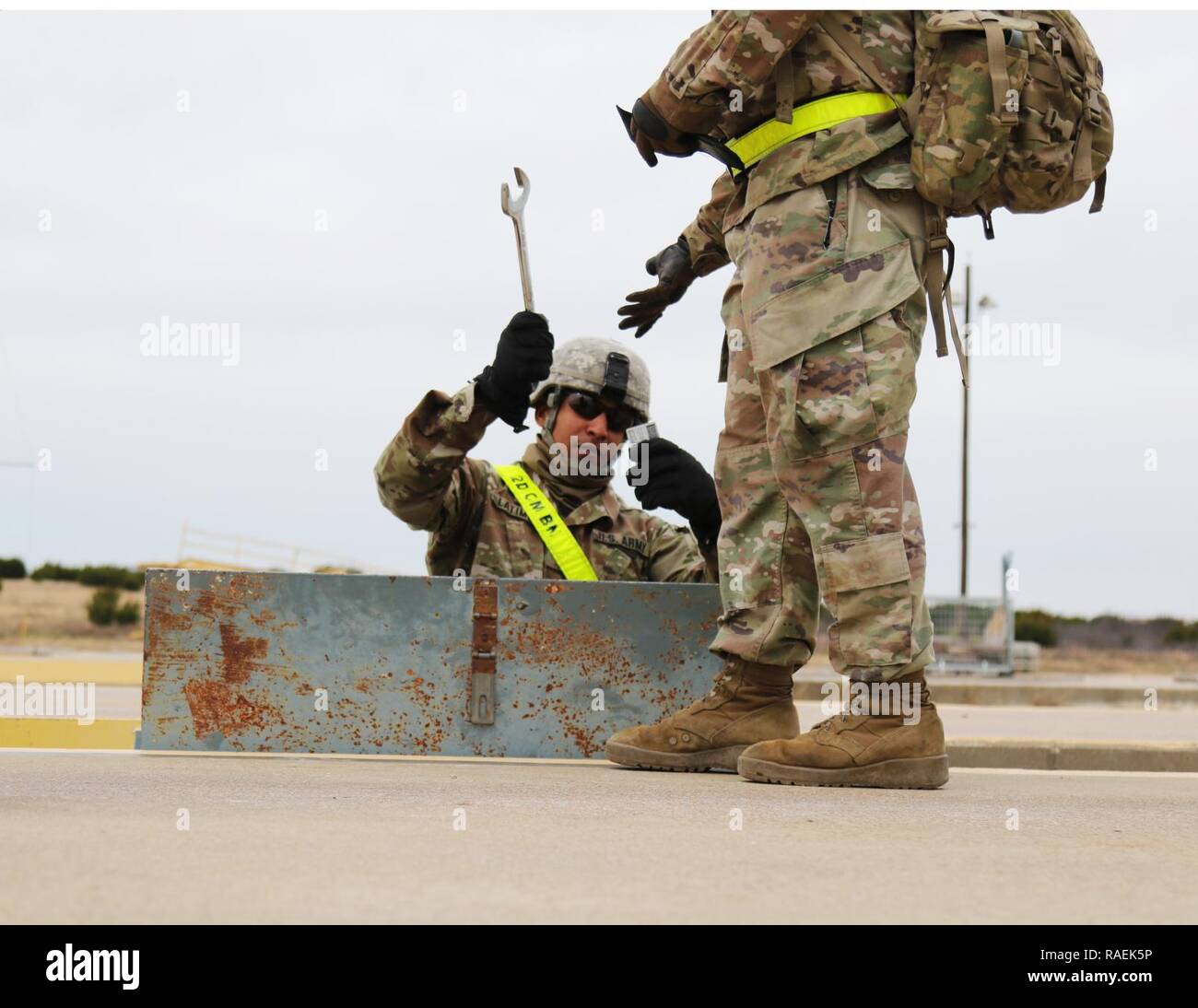 Chief Warrant Officer 2 Francisco Latimer, 68th Chemical Company, 2nd Chemical Battalion, 48th Chemical Brigade, hands a tool to a Soldier while checking identification, Dec. 12, 2018, Fort Hood Texas. Soldiers were checking out tools to assist with tie down of vehicles on the rail. Stock Photo