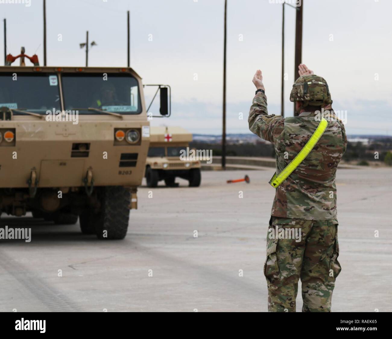 Sgt. Cody Christian, 62ned Expeditionary Signal Battalion, 11th Signal Brigade, guides a vehicle onto the rail, Dec. 12, 2018, Fort Hood, Texas. Soldiers were prepping vehicles for movement to another location. Stock Photo