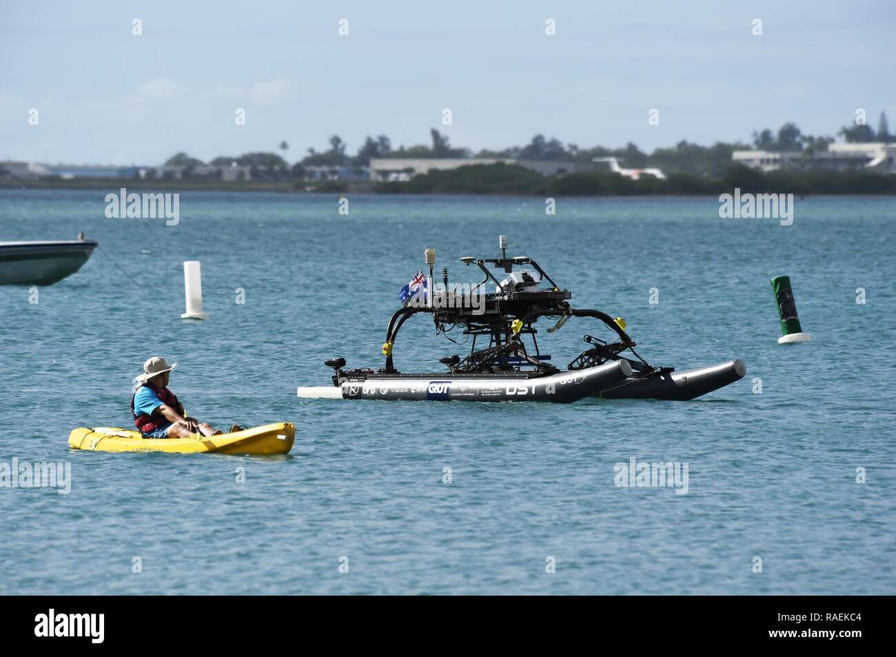 HONOLULU, Hawaii (Dec. 12, 2018) A judge observes the autonomous surface vehicle from Queensland University of Technology as it competes during the Office of Naval Research (ONR)-sponsored Maritime RobotX Challenge in Honolulu, Hawaii. Organized by RoboNation and Navatek, RobotX is designed to foster student interest in autonomous robotic systems operating in the maritime domain, with an emphasis on the science and engineering of cooperative autonomy. Stock Photo