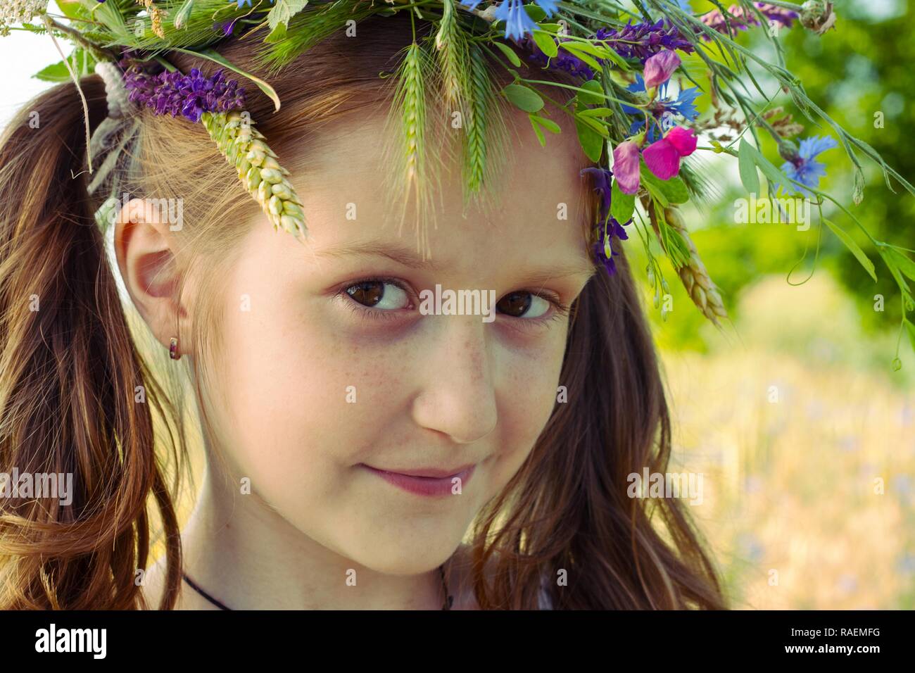 beautiful girl with a wreath of flowers on her head Stock Photo - Alamy