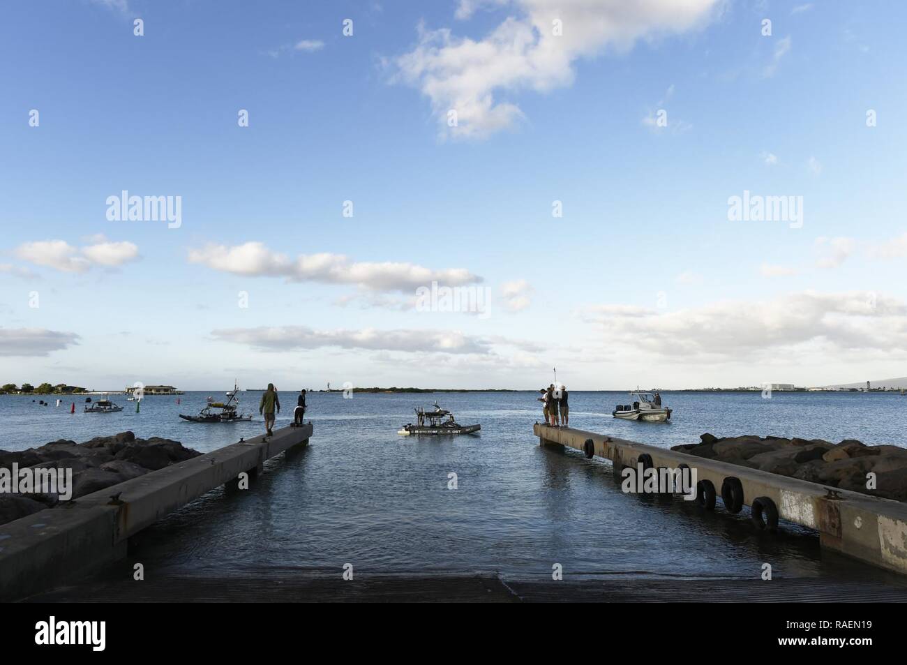 HONOLULU, Hawaii (Dec. 14, 2018) Teams, including Queensland University of Technology, launch their autonomous surface vehicle during the next to last day of competition at the Office of Naval Research (ONR)-sponsored Maritime RobotX Challenge in Honolulu, Hawaii. Fifteen teams from the United States, Australia and Asia, compete in the biennial challenge designed to foster student interest in autonomous robotic systems operating in the maritime domain, with an emphasis on the science and engineering of cooperative autonomy. Stock Photo