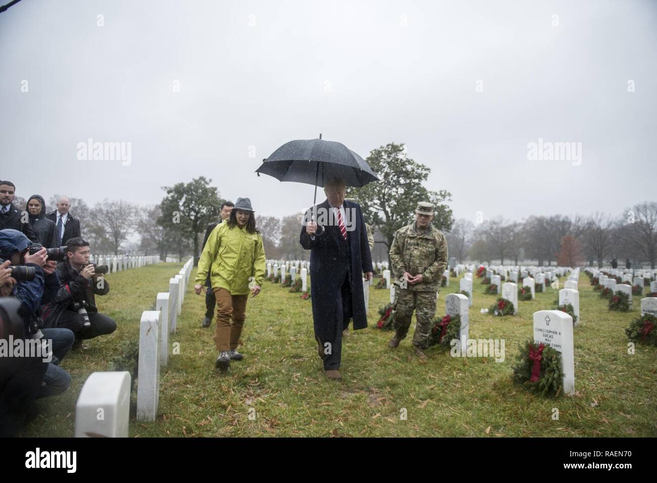 President Donald J. Trump (center) visits with Karen Durham-Aguilera (center left), executive director, Army National Military Cemeteries;  and U.S. Army Sgt. Maj. Juan Abreu (right), senior enlisted advisor, Arlington National Cemetery and Army National Military Cemeteries in Section 60 of Arlington National Cemetery, Arlington, Virginia, Dec. 15, 2018. Stock Photo