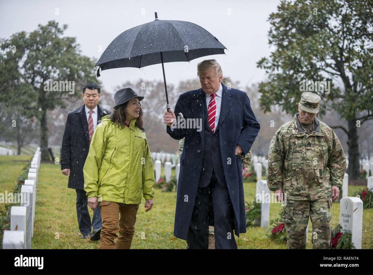 President Donald J. Trump (center) visits with Karen Durham-Aguilera (left), executive director, Army National Military Cemeteries; and U.S. Army Sgt. Maj. Juan Abreu (right), senior enlisted advisor, Arlington National Cemetery and Army National Military Cemeteries in Section 60 of Arlington National Cemetery, Arlington, Virginia, Dec. 15, 2018. Stock Photo