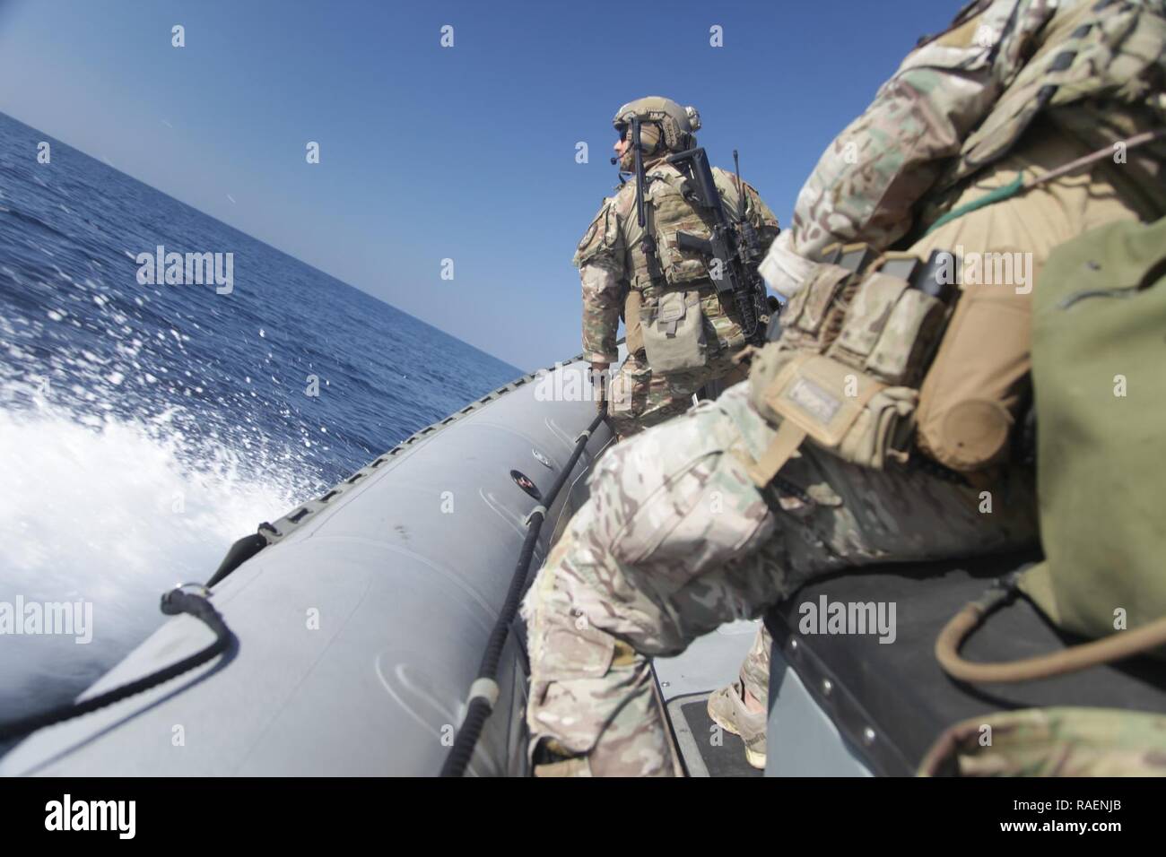 GULF OF OMAN (Dec. 13, 2018) U.S. Coast Guard Maritime Security Response Team personnel train on a rigid-hull inflatable boat from the Cyclone-class coastal patrol ship USS Thunderbolt (PC 12)  in the Gulf of Oman. Thunderbolt is deployed to the U.S. 5th Fleet area of operations in support of naval operations to ensure maritime stability and security in the Central Region, connecting the Mediterranean and the Pacific through the western Indian Ocean and three strategic choke points. Stock Photo