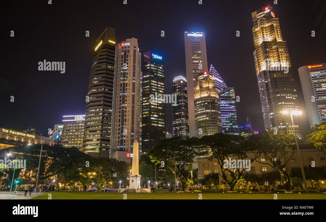Dalhousie Obelisk at night with Raffles Place in the background at night, Singapore Stock Photo