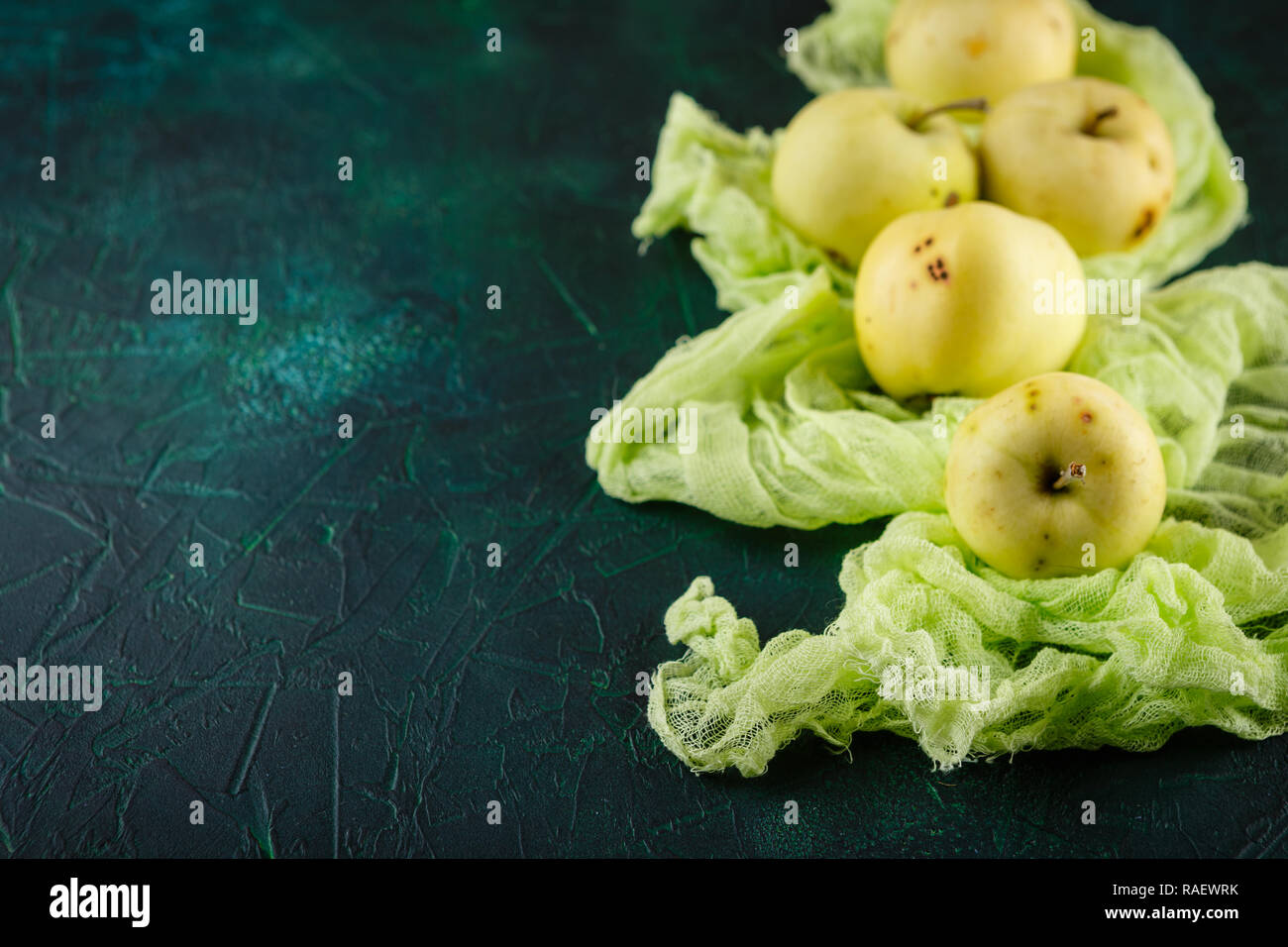Fresh green apples on dark green background Stock Photo
