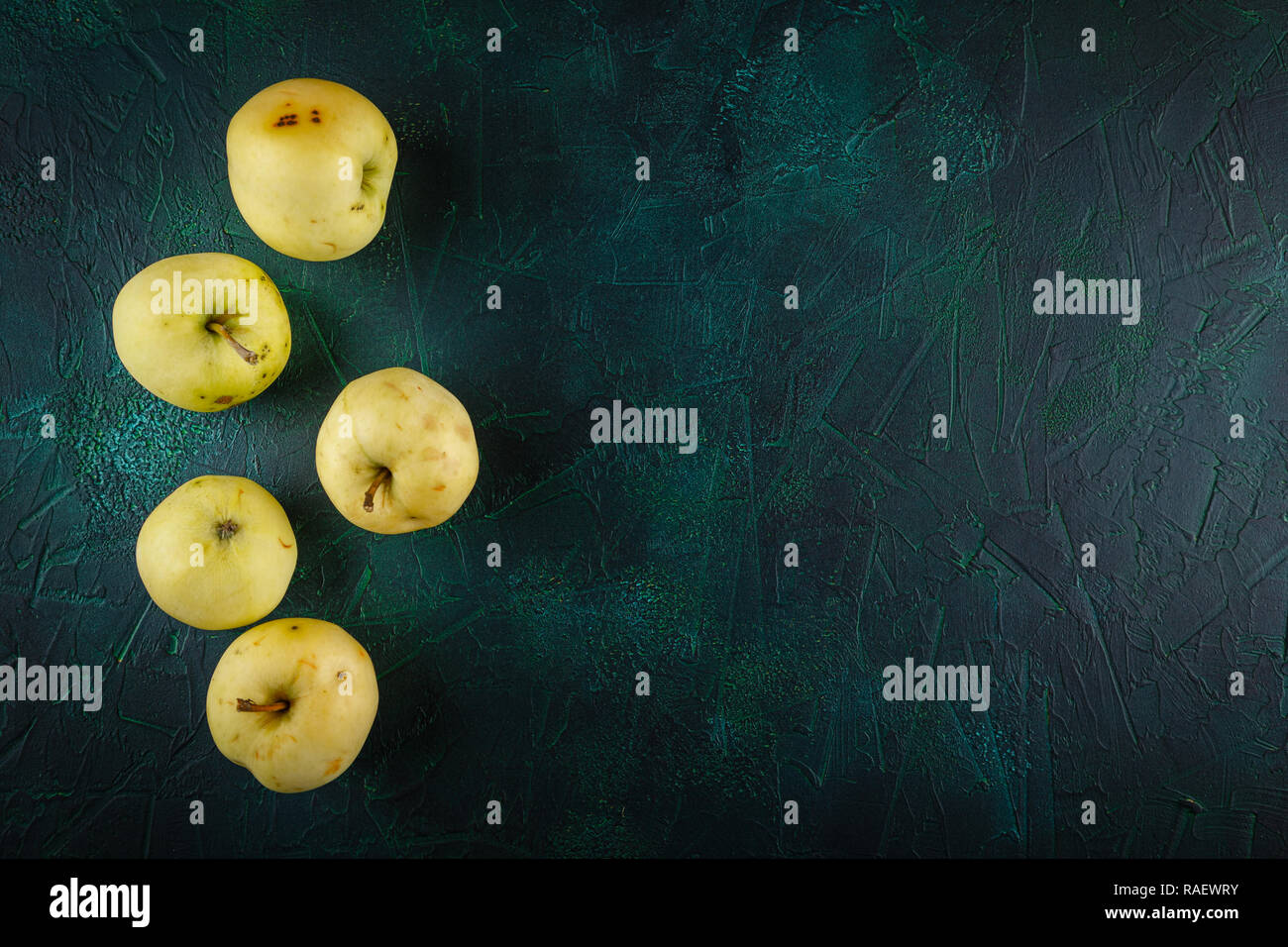Fresh green apples on dark green background Stock Photo