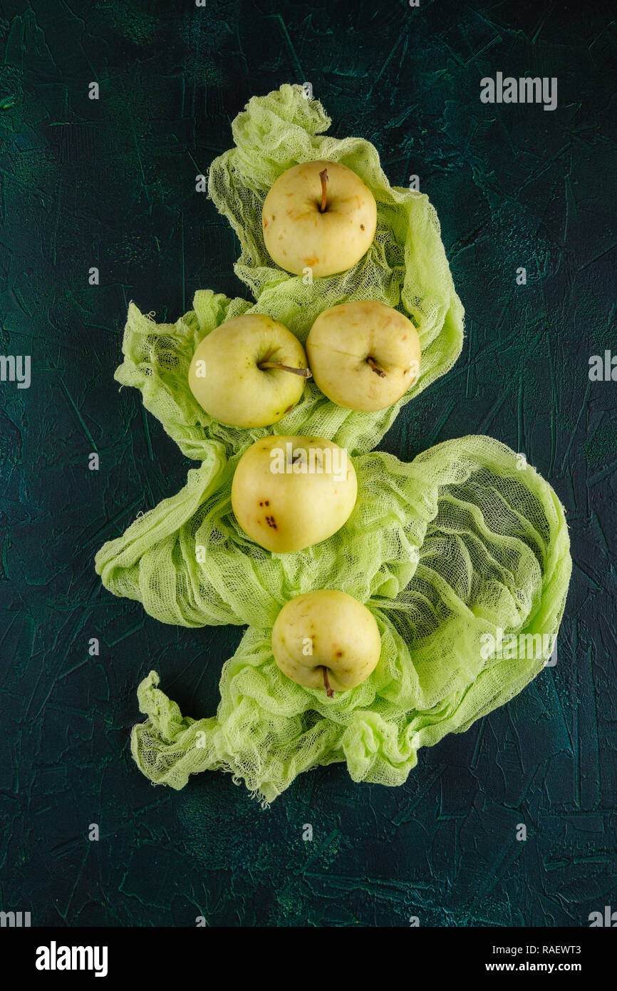 Fresh green apples on dark green background Stock Photo