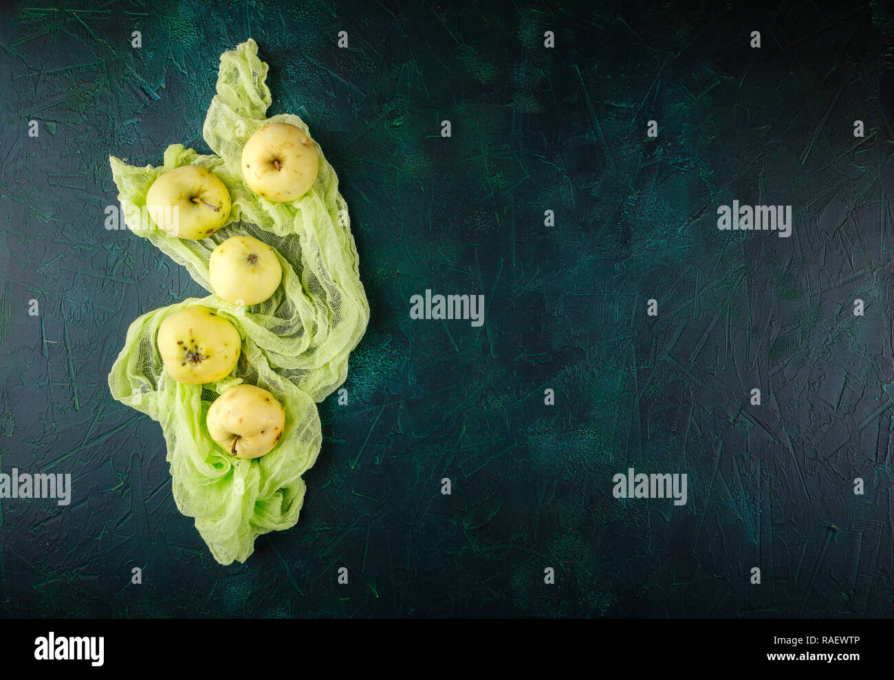 Fresh green apples on dark green background Stock Photo