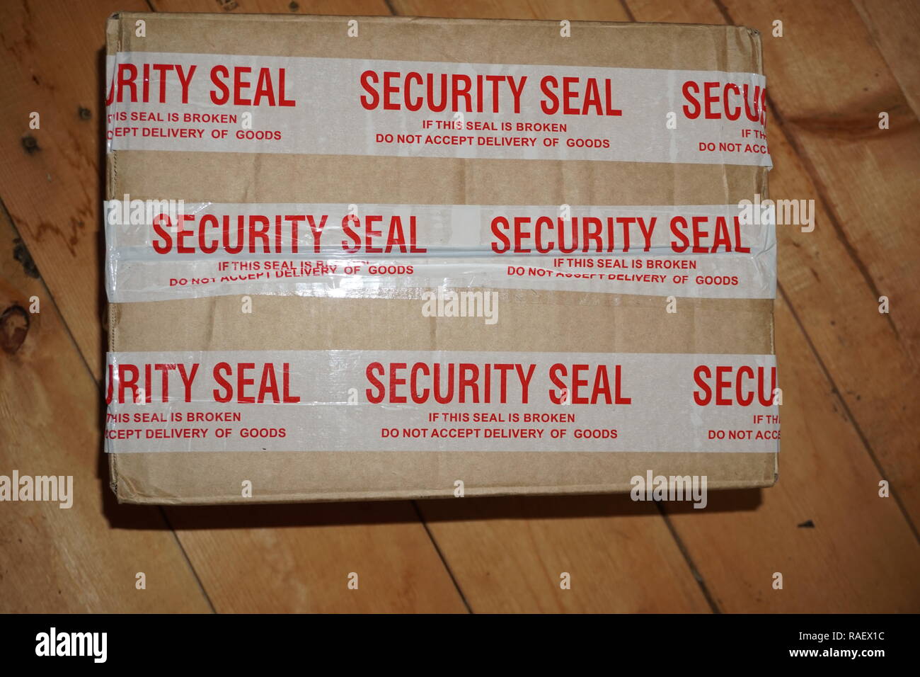 shipping box with security seal tape 'if this seal is broken, do not accept delivery of goods' Stock Photo