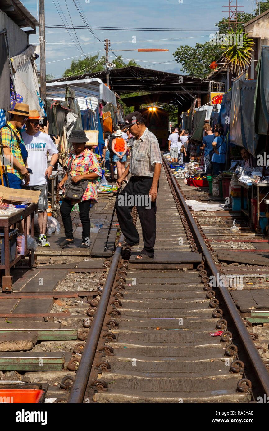 The Mae Klong Railway Market, or Bangkok Train Market, is a strange market just outside of Bangkok. Currently it is already a tourist attraction Stock Photo