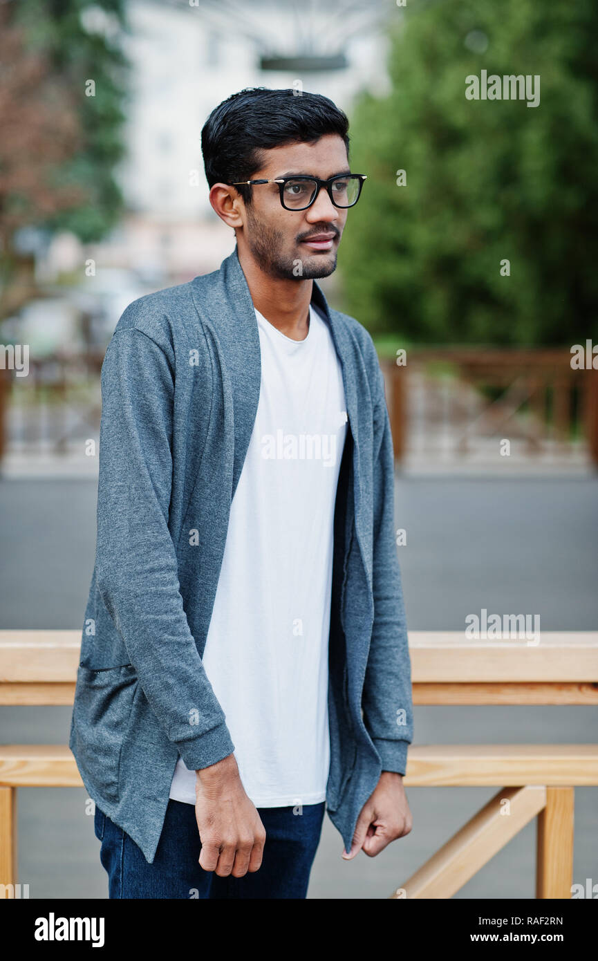 Stylish indian young man at sunglasses wear casual posed outdoor against  door of building Stock Photo - Alamy