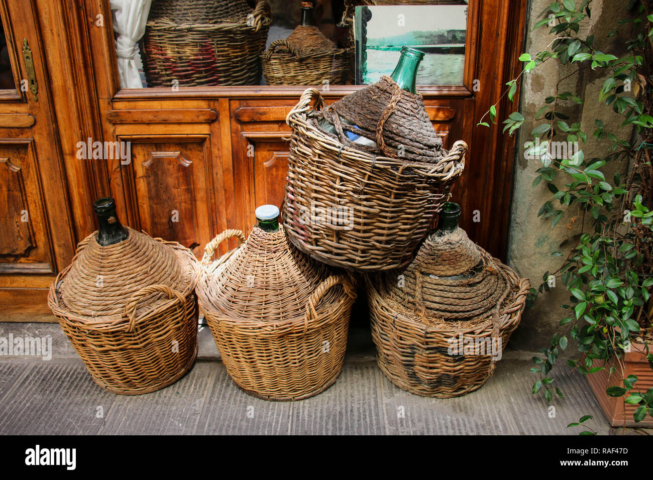 Empty wine bottles in wicker baskets Stock Photo Alamy