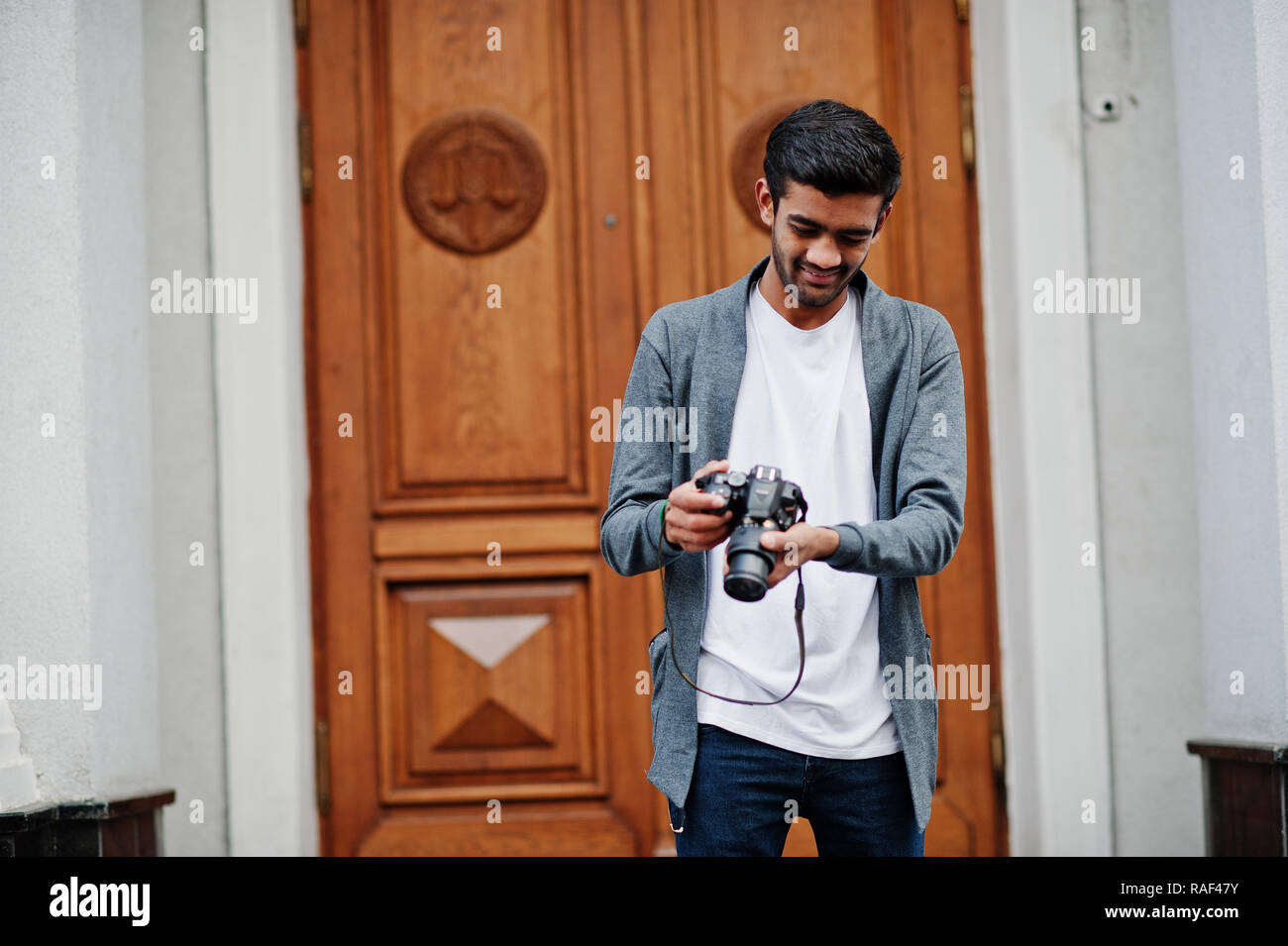 Photographer shooting hands close up with dslr camera and model posing on  background at studio Stock Photo - Alamy