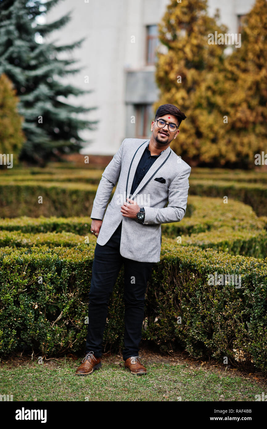 Stylish indian man with bindi on forehead and glasses, wear on suit ...