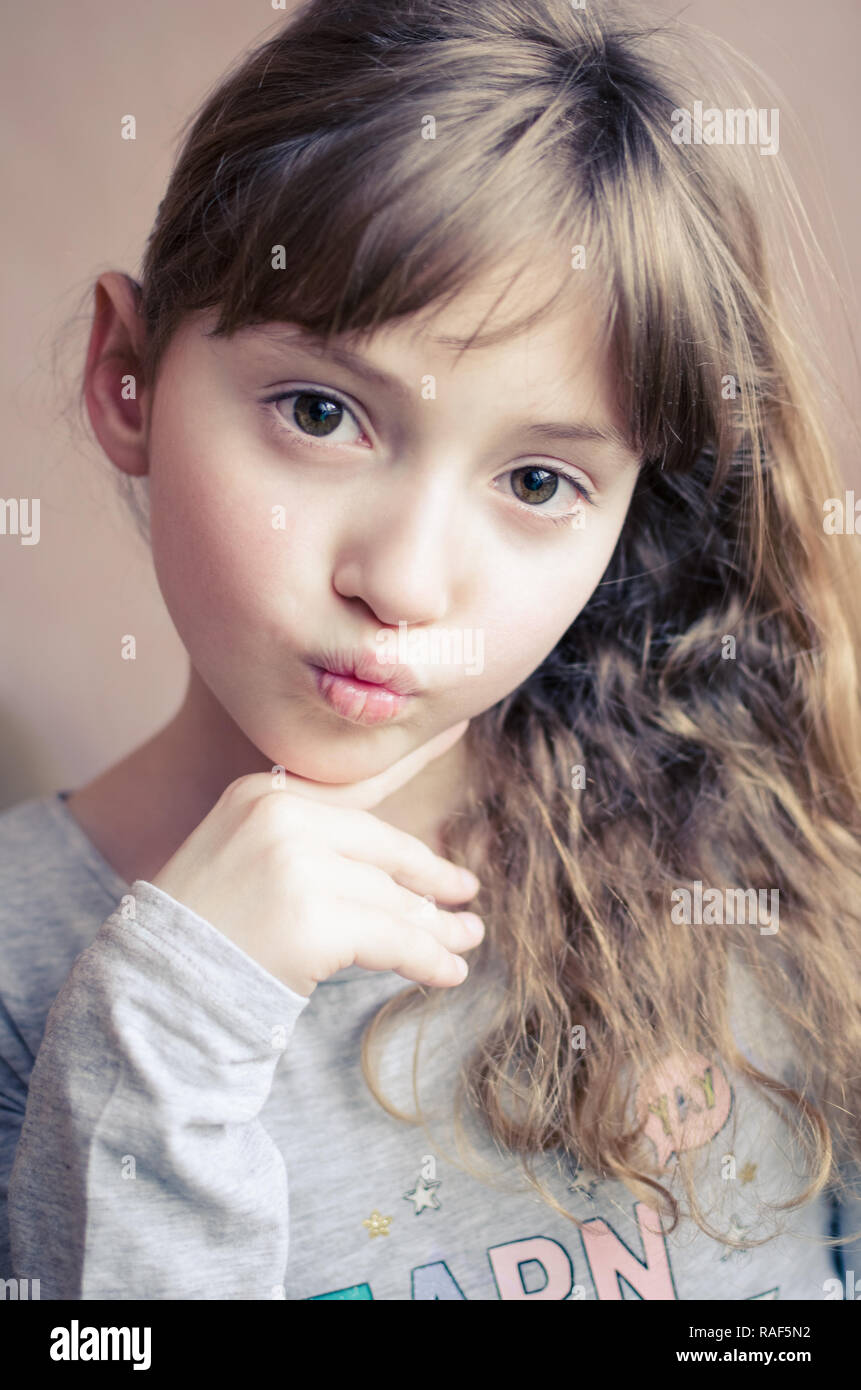 Portrait of little pretty girl make an air kiss. Beautiful girl