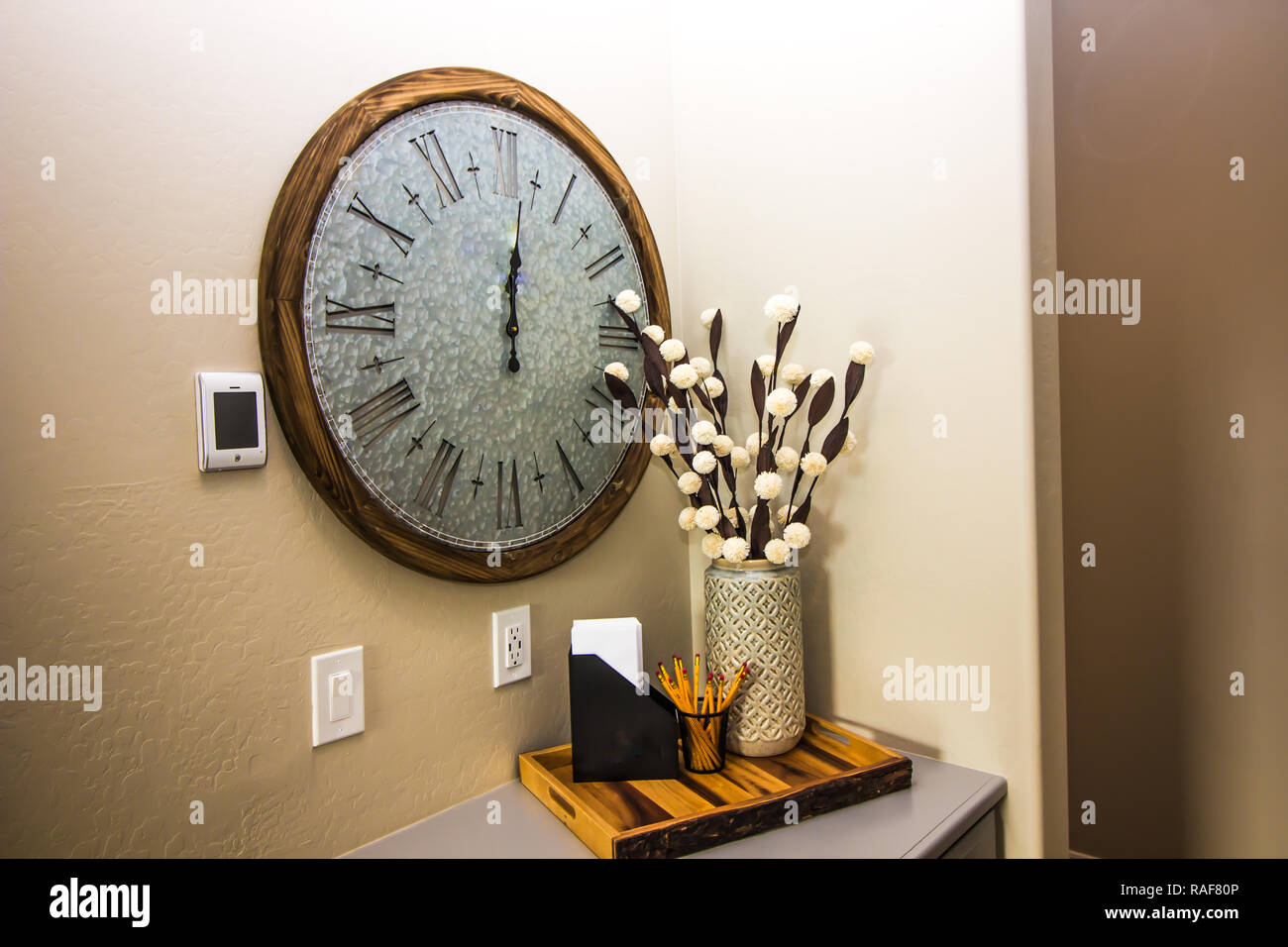 Large Wall Clock and Tray In Entryway Stock Photo Alamy
