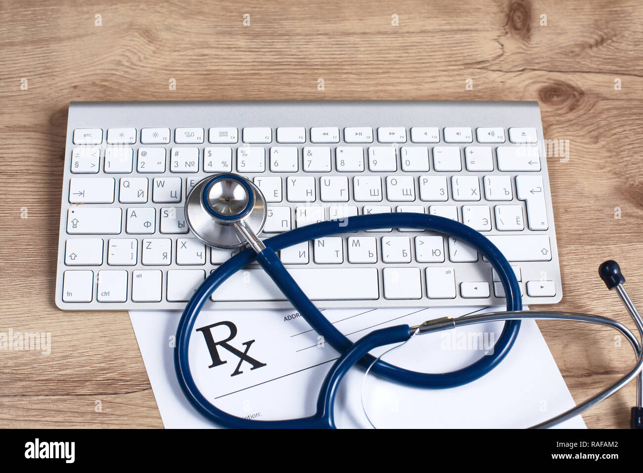 Stethoscope lying on a laptop keyboard in a concept of online medicine