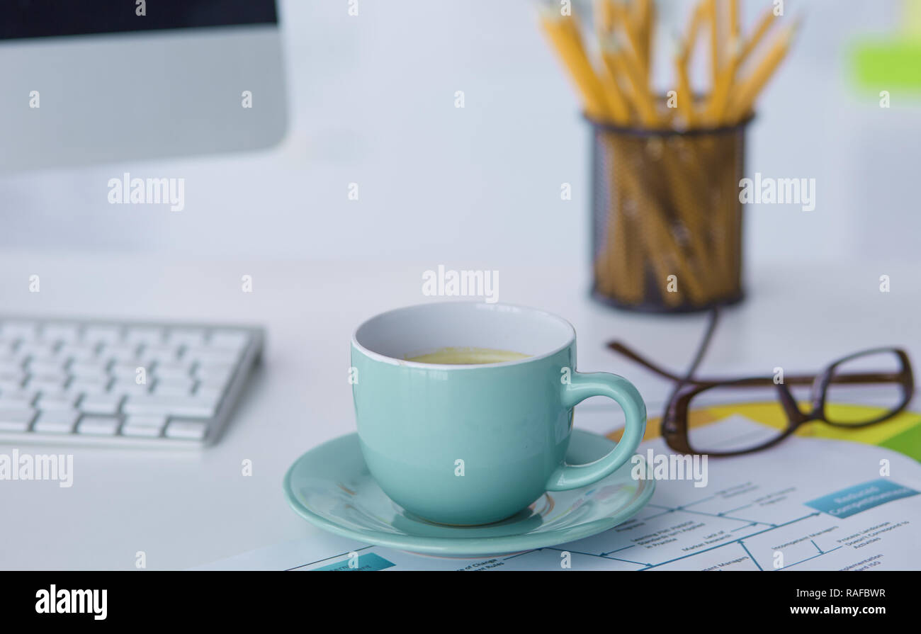 A cup of coffee on the office table Stock Photo - Alamy