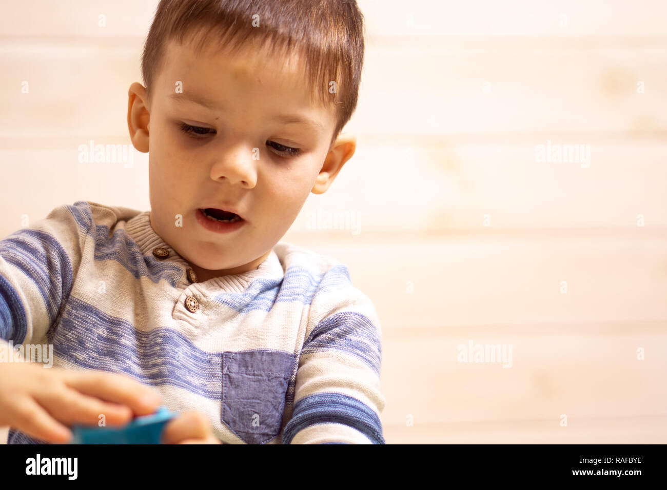 little boy plays with toy car at home Stock Photo - Alamy