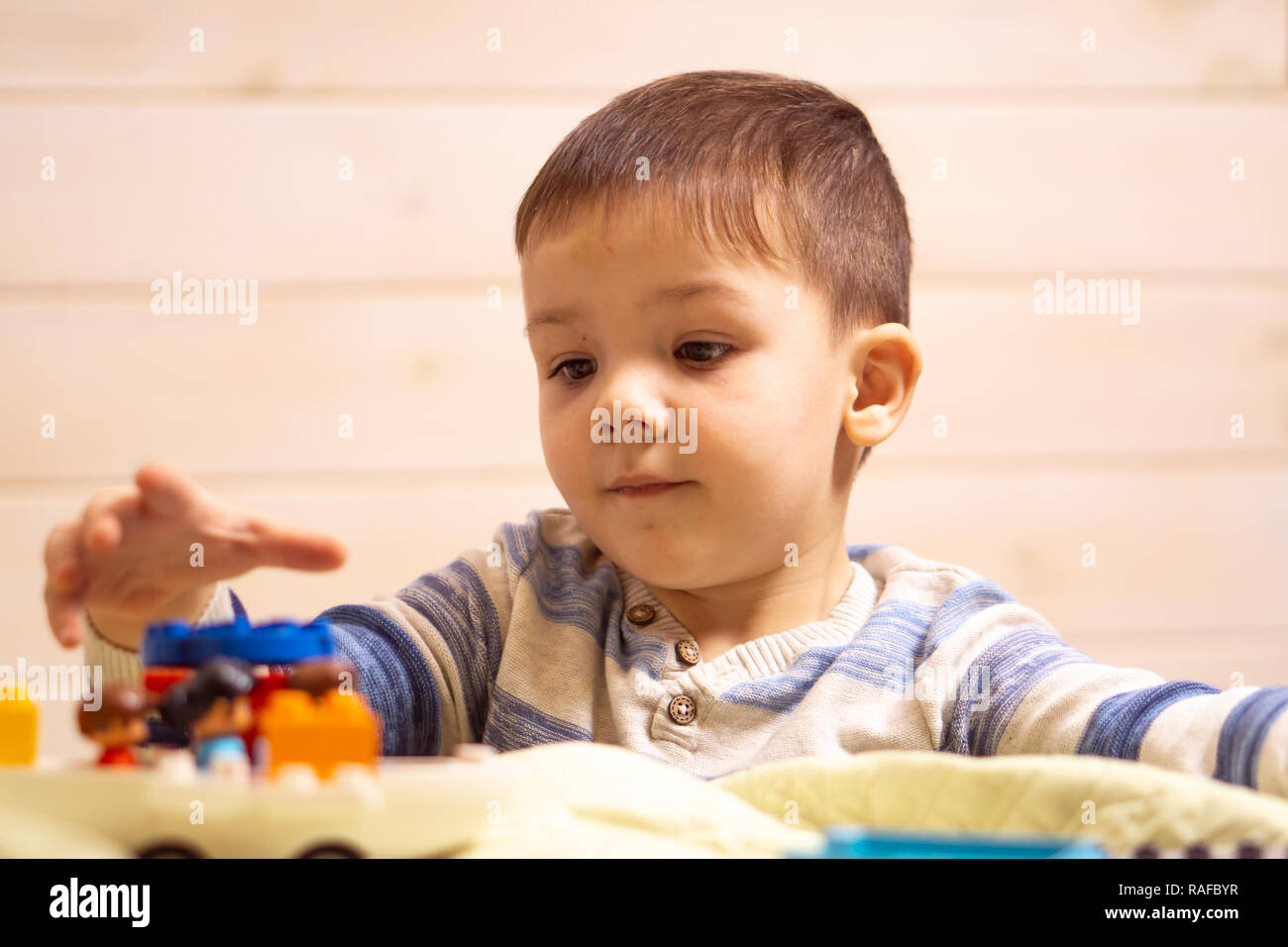 little boy plays with toy car at home Stock Photo - Alamy