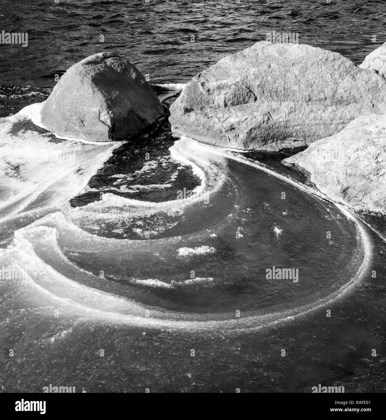 Black & white view of ice on the Arkansas River which runs through the downtown historic district of the small mountain town of Salida, Colorado, USA Stock Photo