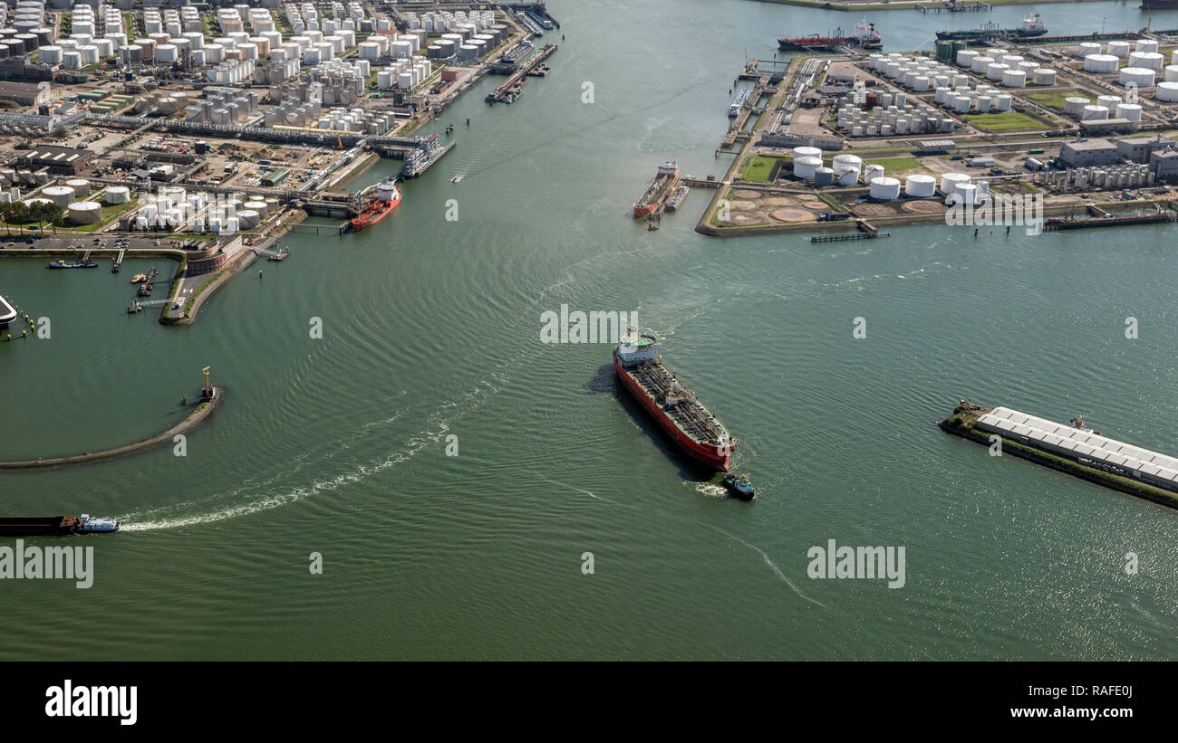 Aerial view of oil tankers moored at an oil storage silo terminal port. Stock Photo