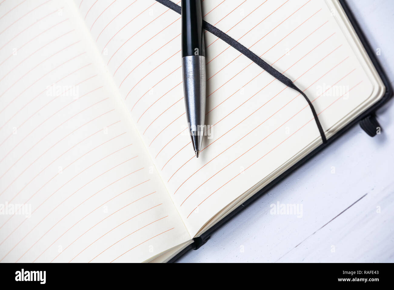 White notepad notebook lines elegant pen grey wooden background Stock Photo