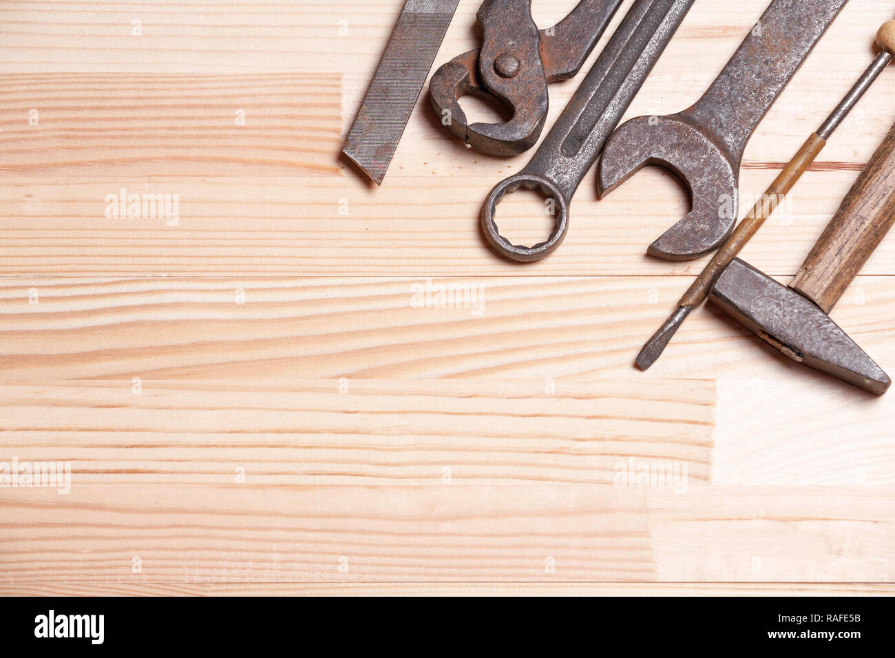Rusty rugged old work industrial tools key wrench screw driver light natural wooden background Stock Photo