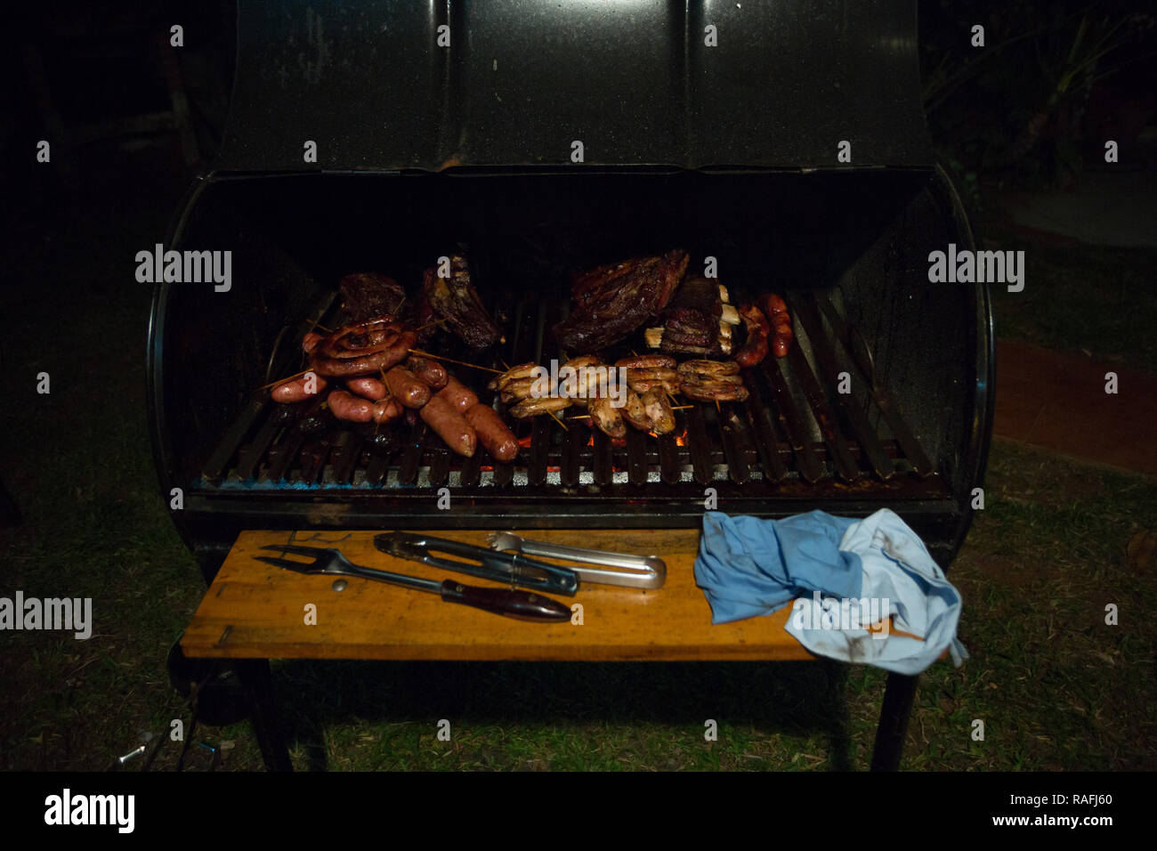 Homemade 'asado a la parrilla' (barbecue on the grill), on an outdoor 'parrilla  tambor' (tank grill) during Christmas Eve, Asuncion, Paraguay Stock Photo -  Alamy