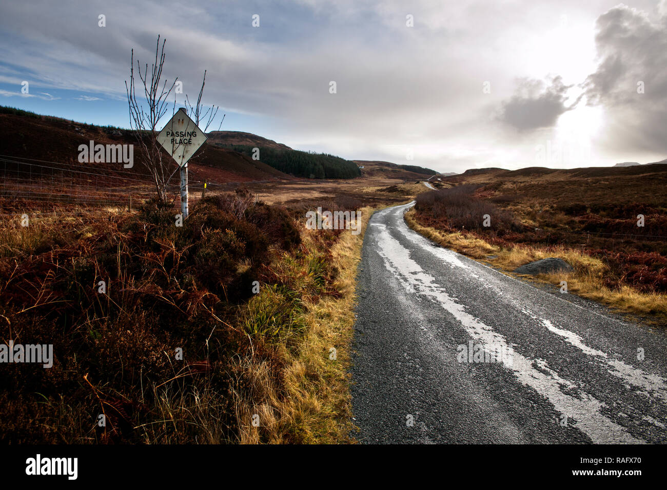 deserted desolate winding roads with snow and ice disappearing into the distance Stock Photo