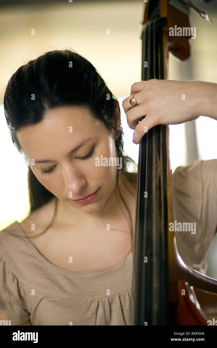 Woman playing her double bass. Stock Photo