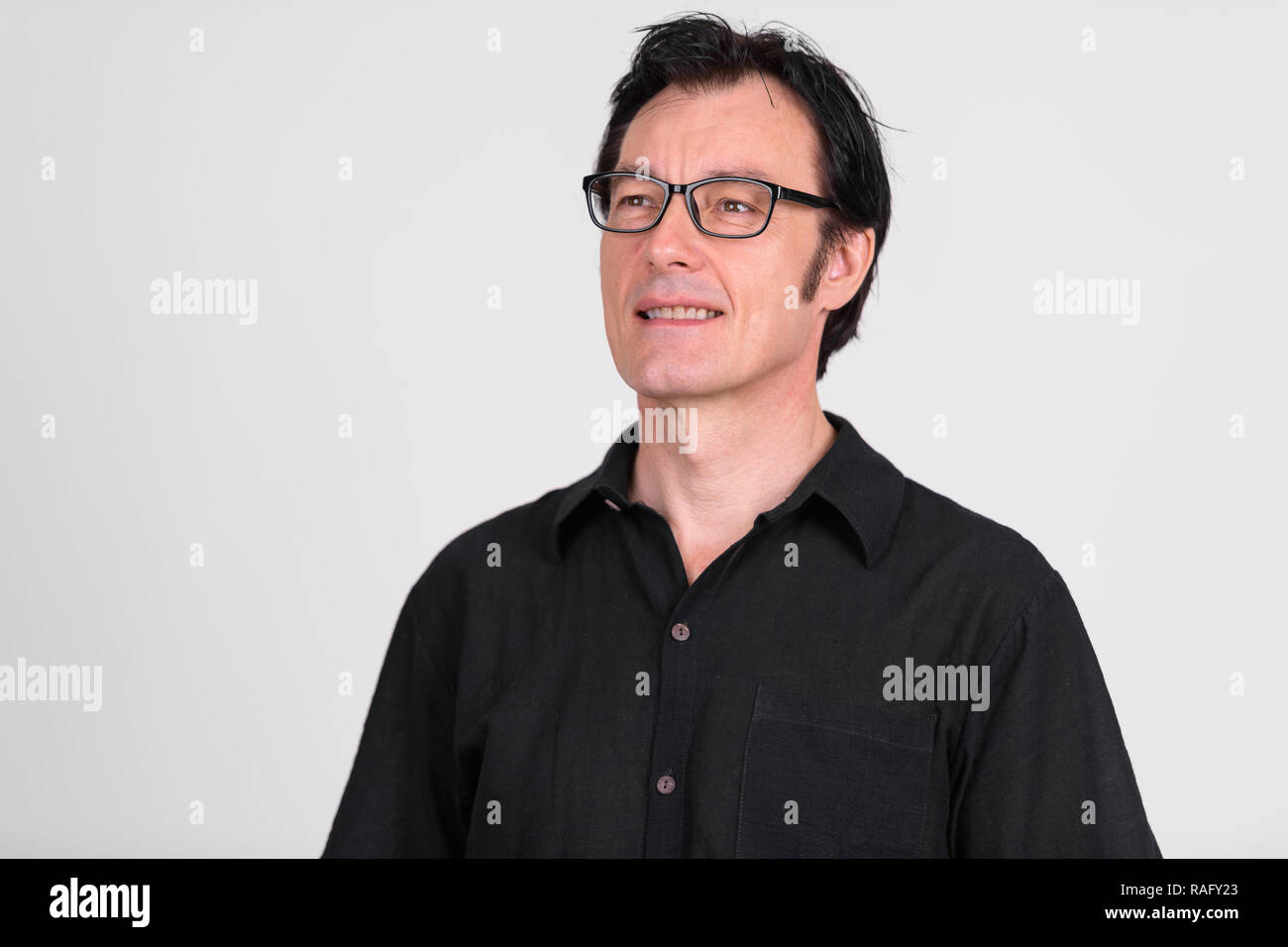Happy mature handsome man with eyeglasses smiling while thinking Stock ...